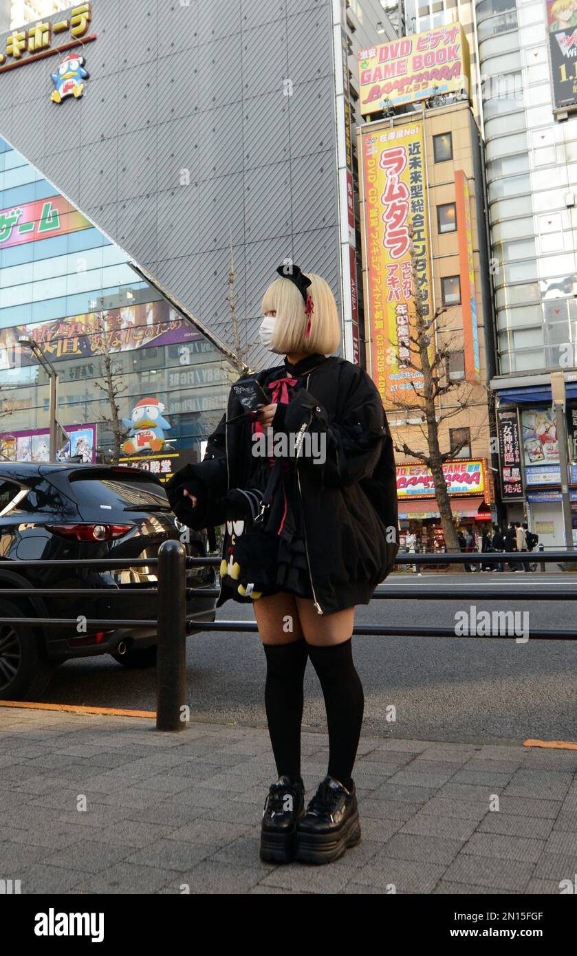 Girls dressed in French maid costumes handing out discount coupons for