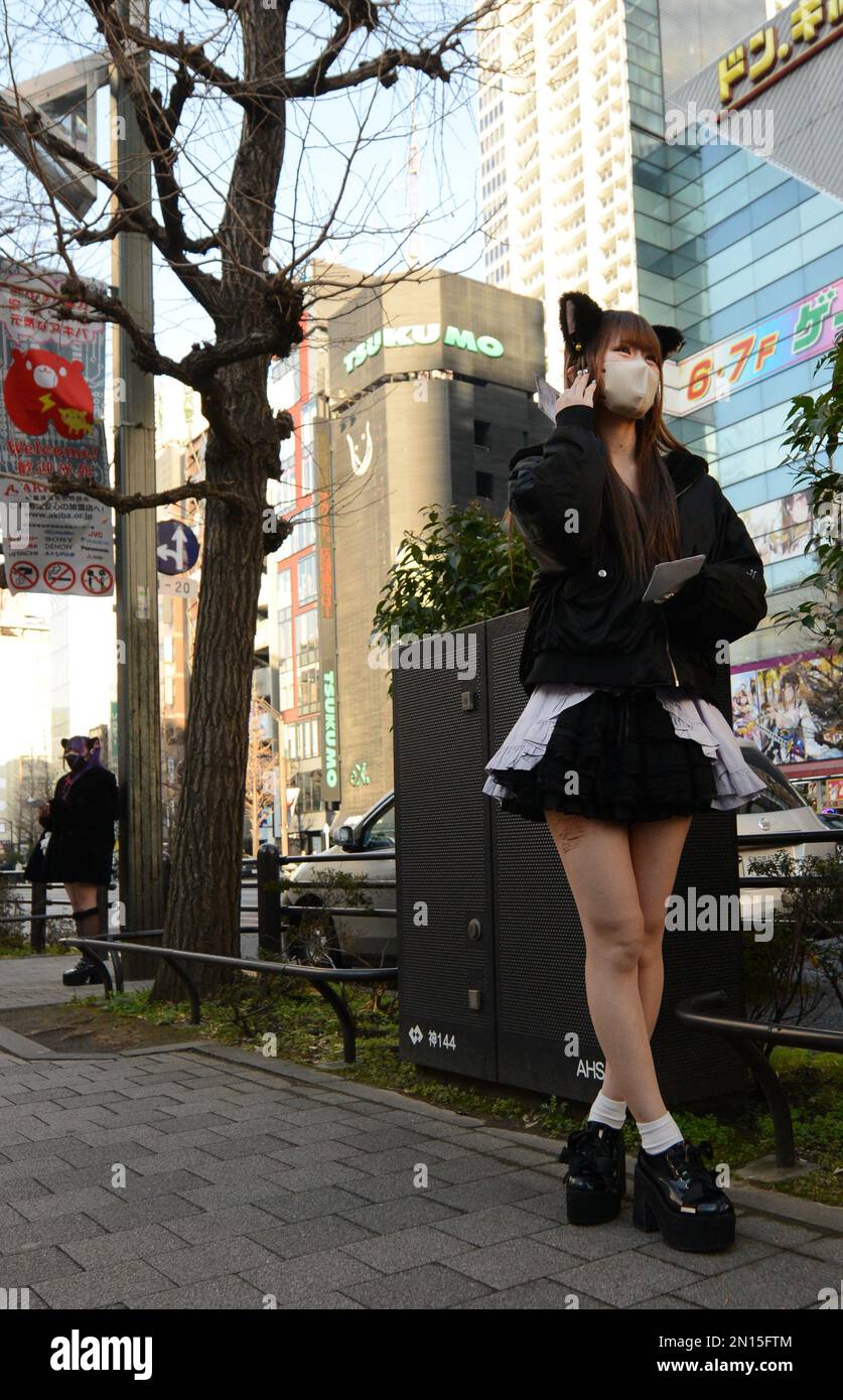Girls dressed in French maid costumes handing out discount coupons for
