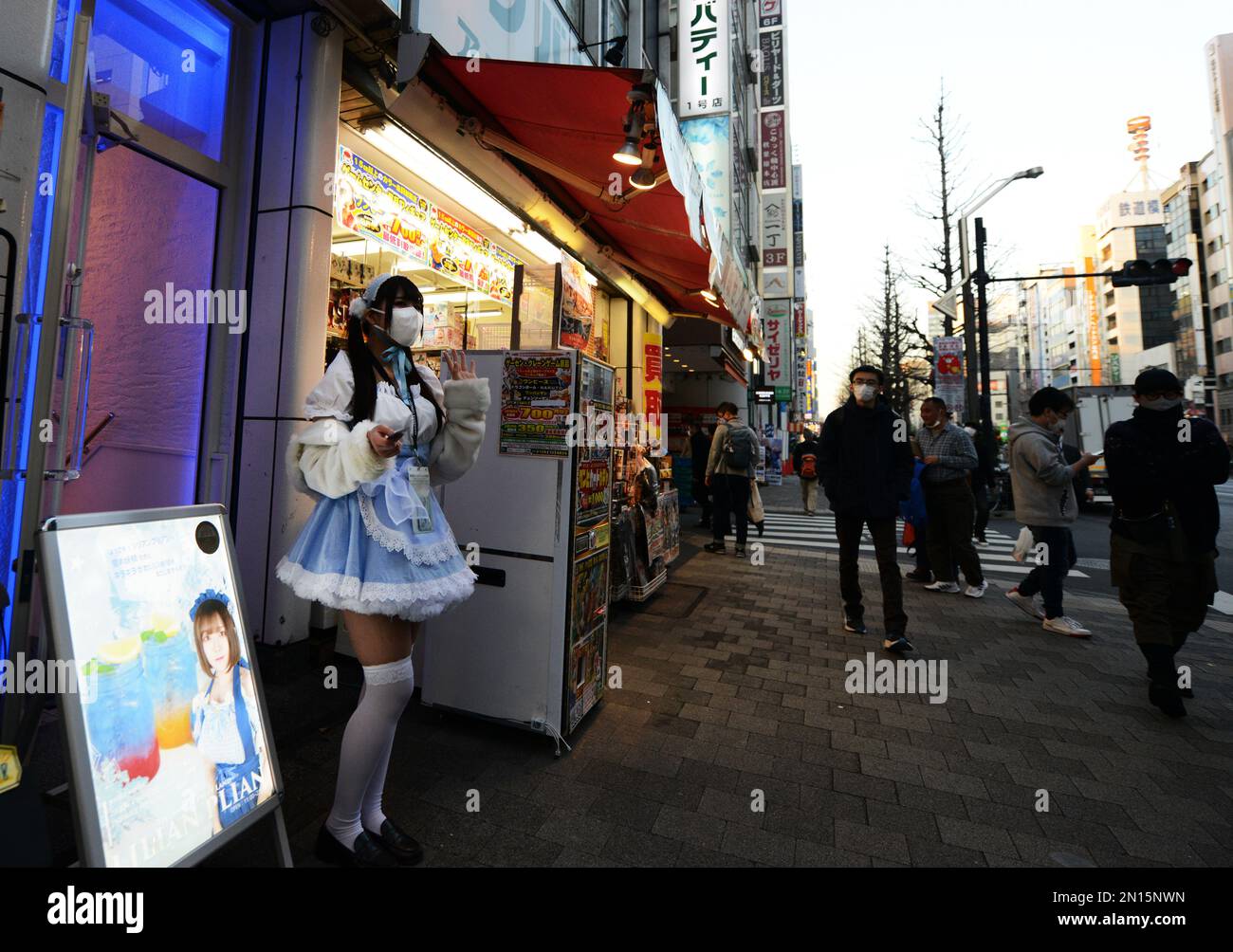 Girls dressed in French maid costumes handing out discount coupons for