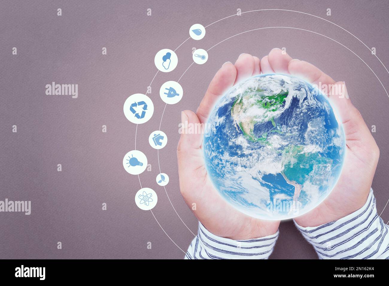 Male holding the globe in hand and sustainable energy graphic icon. Stock Photo