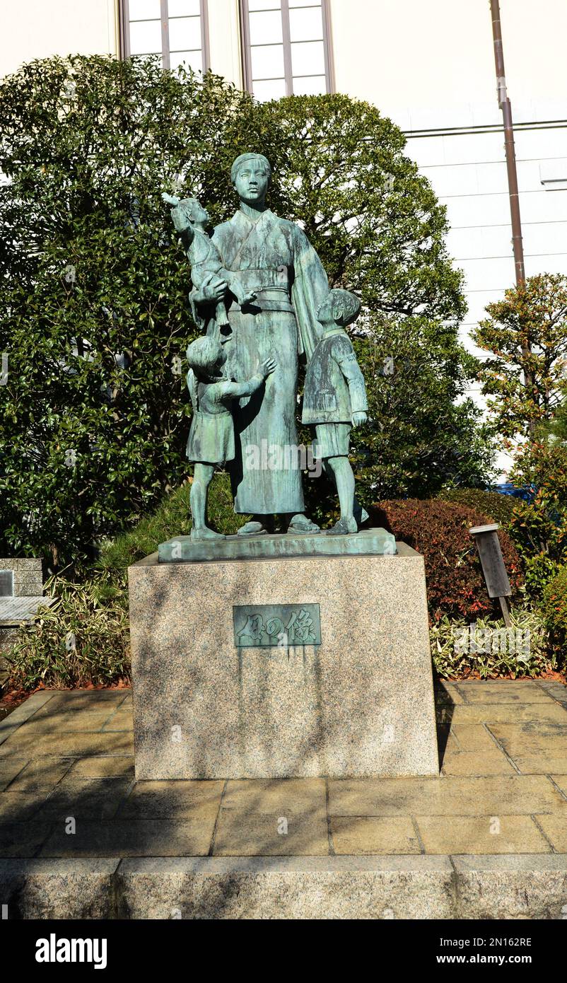 Statue of mother with children near the entrance of the Yasukuni war memorial museum in Tokyo, Japan. Stock Photo