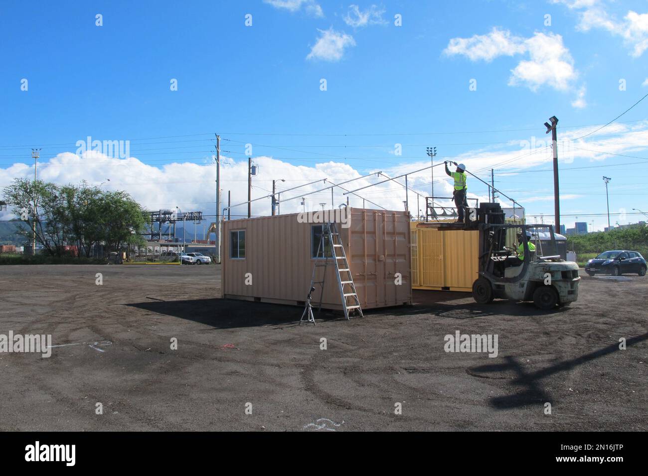 Crews work on an awning at the city's latest homeless shelter on Friday