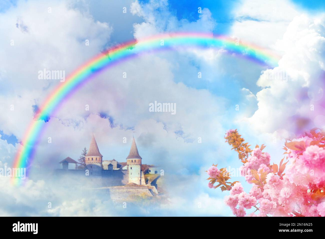 Fantasy world. Beautiful rainbow in sky with fluffy clouds over ...