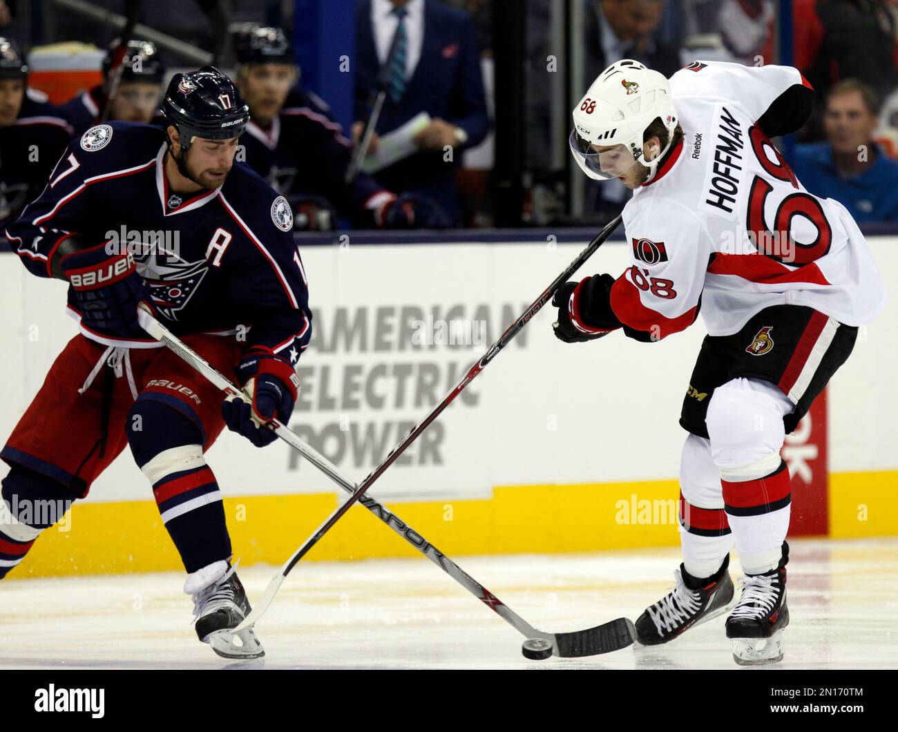Columbus Blue Jackets' Brandon Dubinsky, left, works for the puck ...