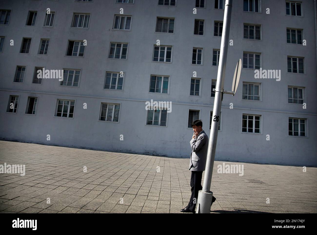 A man walks past a residential building at lunch hour Wednesday, Oct ...