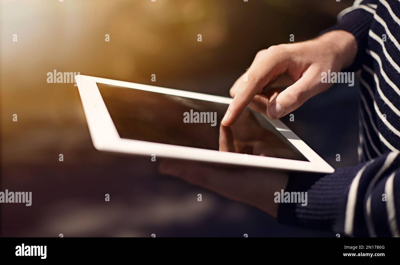 Get in touch with your technology. a man using a digital tablet. Stock Photo