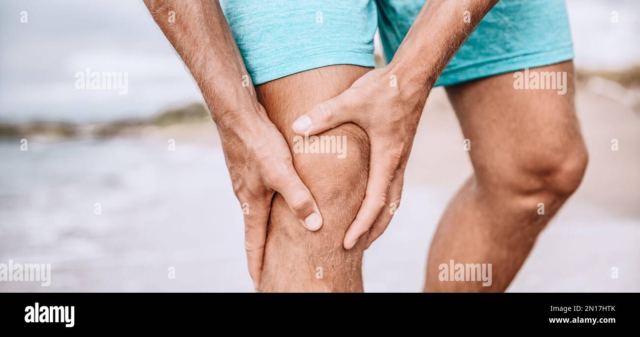Knee pain sport injury from running exercise. Man runner holding
