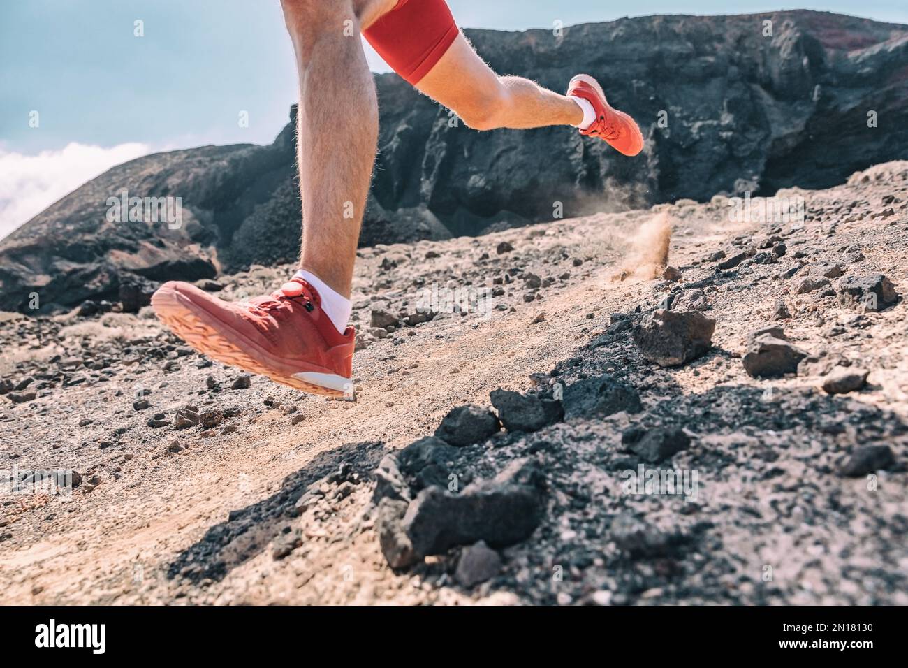 Trail running man on exercising racing fast on volanic trek path in ...