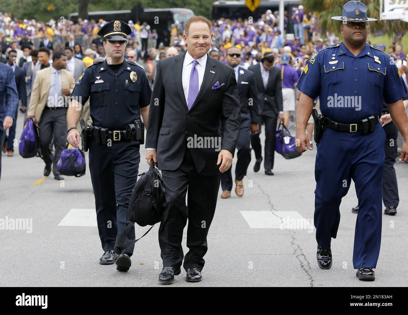 LSU head coach Les Miles makes his way to the stadium before an NCAA