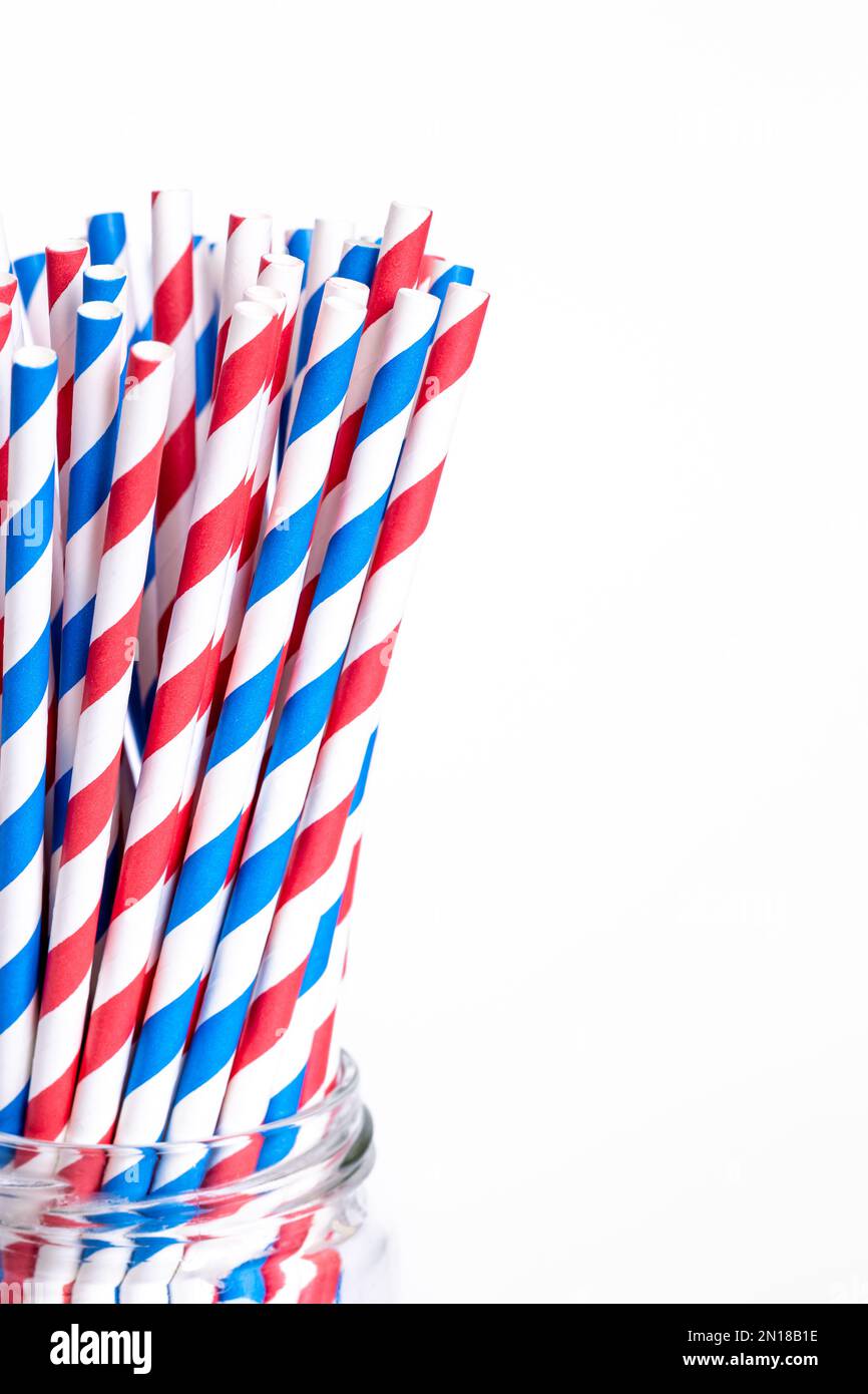 Multi-colored paper straws for drinks close-up on a white background. Stock Photo