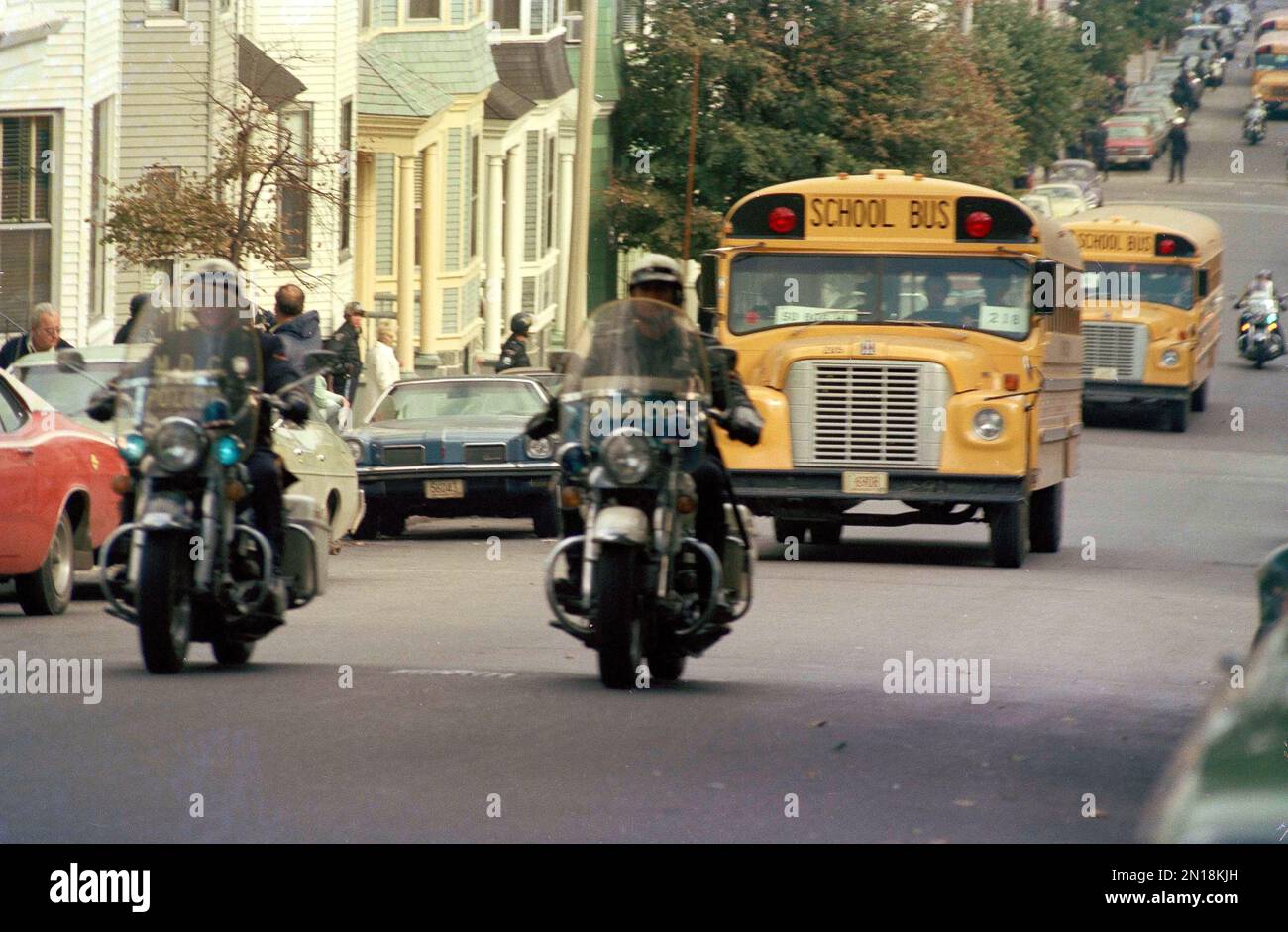 Motorcycle police escort school buses on a street in Boston, Mass., as  schools are desegregated in 1974. (AP Photo Stock Photo - Alamy