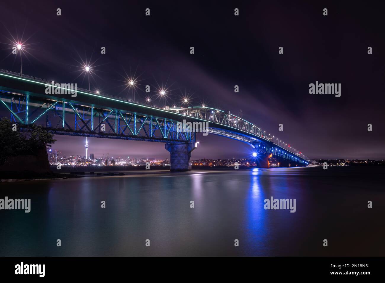 Auckland Harbour Bridge glowing in blue. Auckland, New Zealand Stock