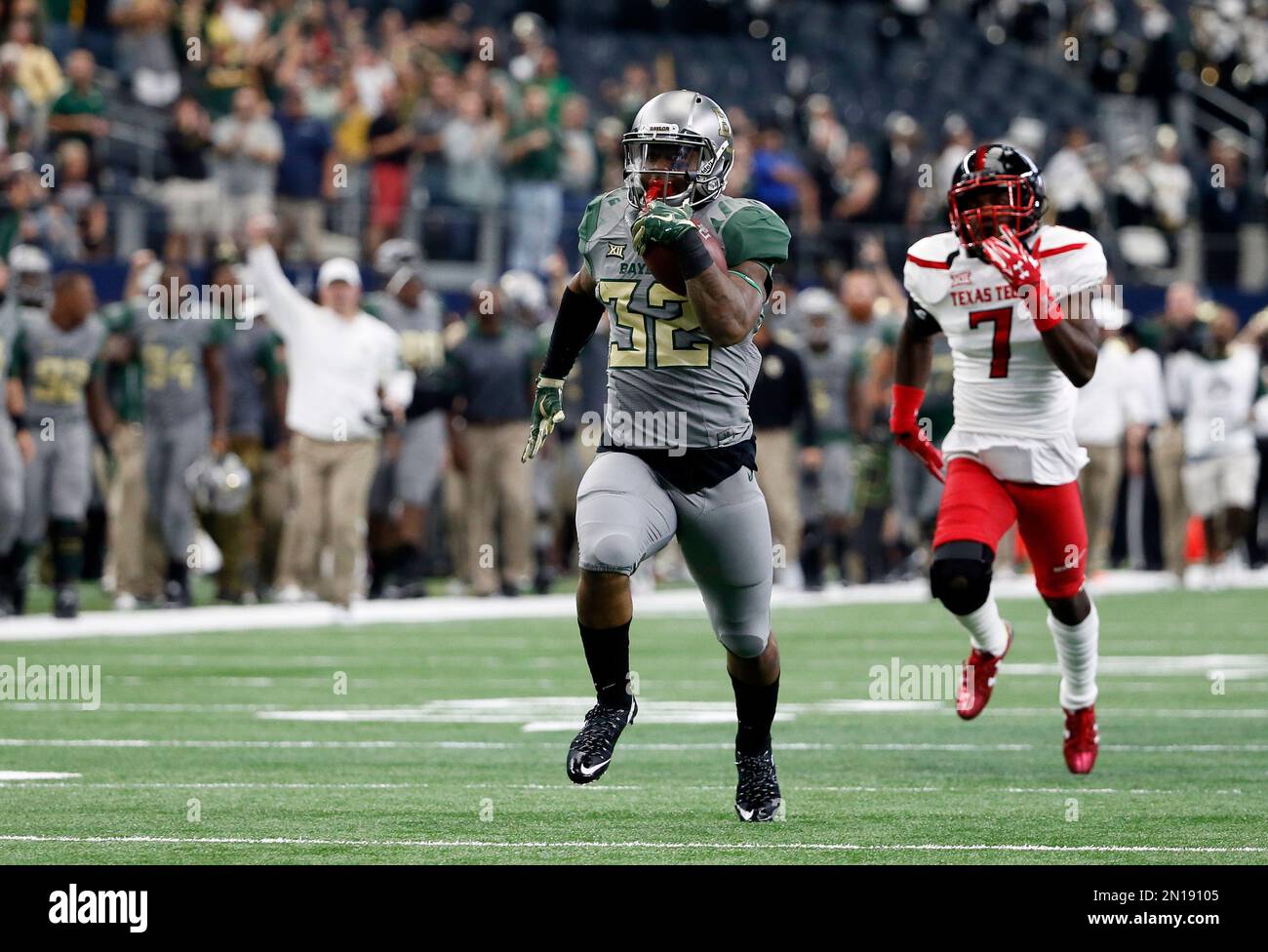 Baylor running back Shock Linwood (32) leads Texas Tech defensive back