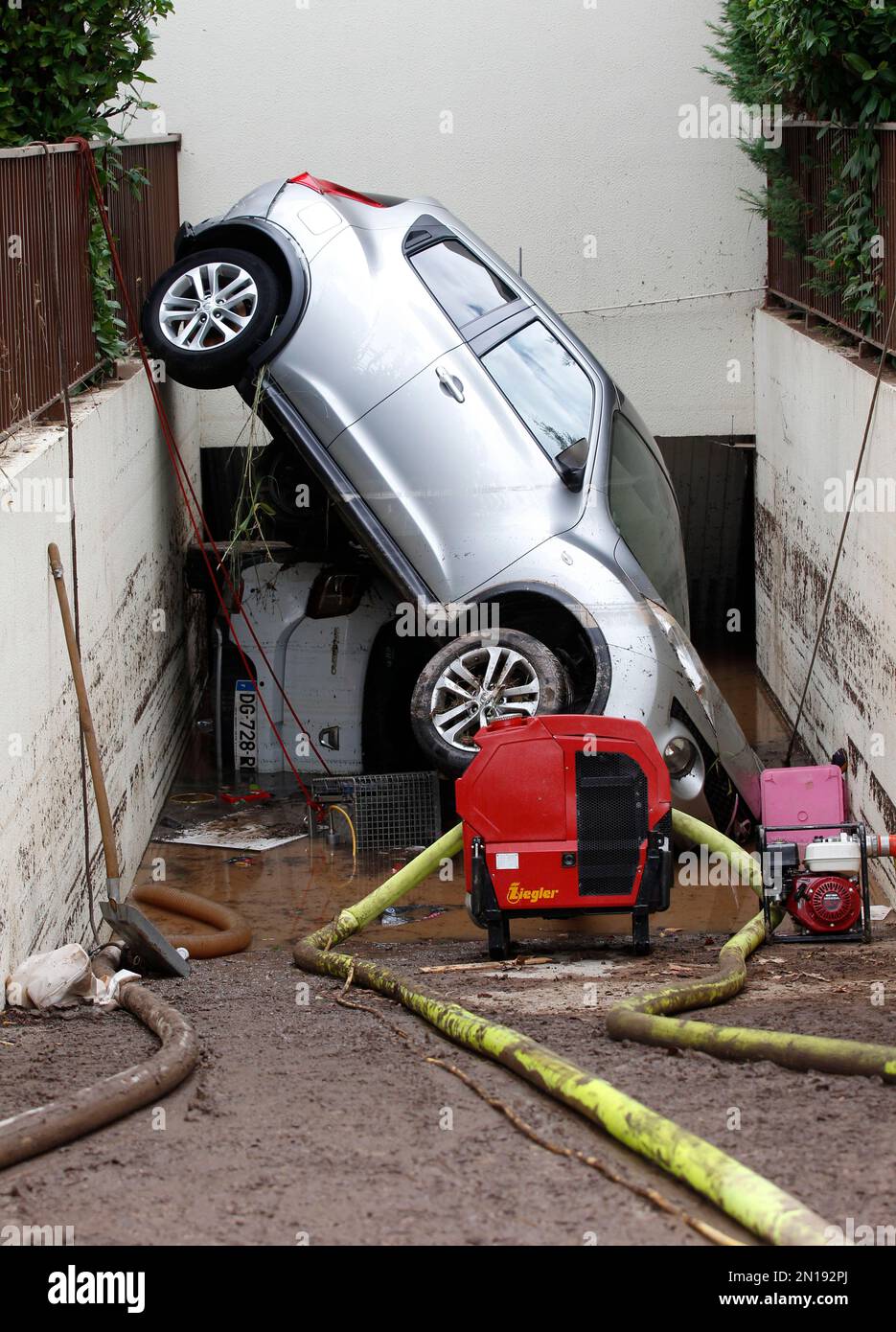 A car block the entrance of a garage after floods in Mandelieu la