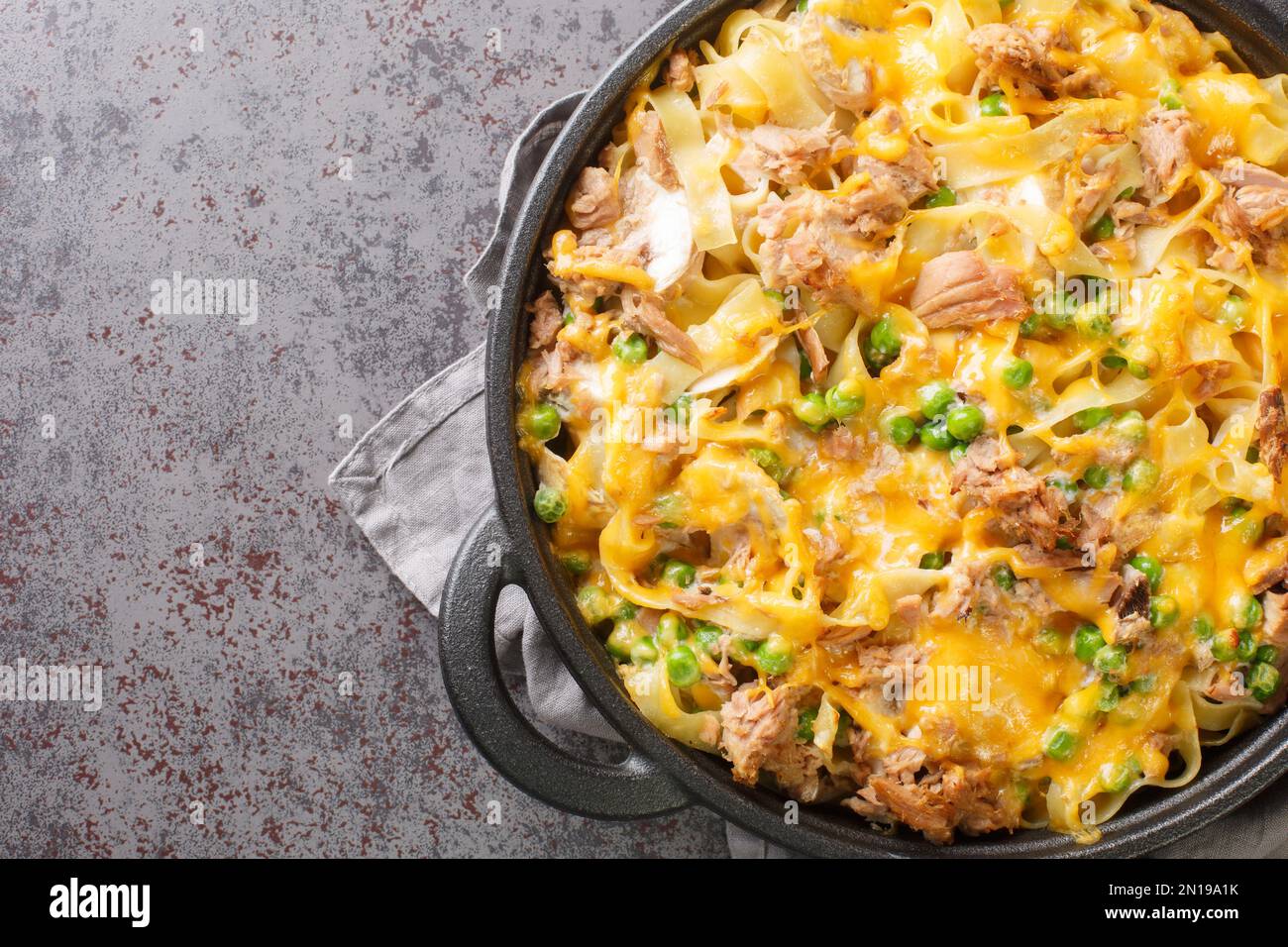 Homemade Tuna casserole with pasta, green peas, mushrooms and cheddar