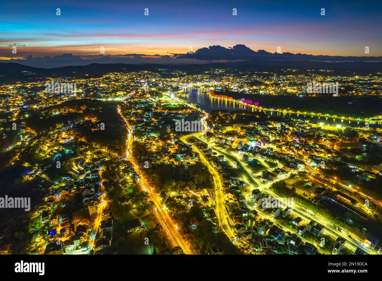 Aerial view of Da Lat city night sunset beautiful tourism destination in central highlands Vietnam. Urban development texture, green parks Stock Photo