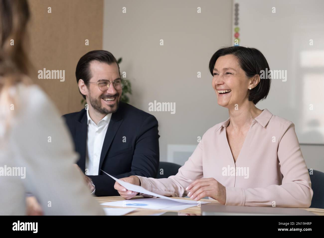 Happy cheerful mature business woman telling funny creative idea Stock Photo