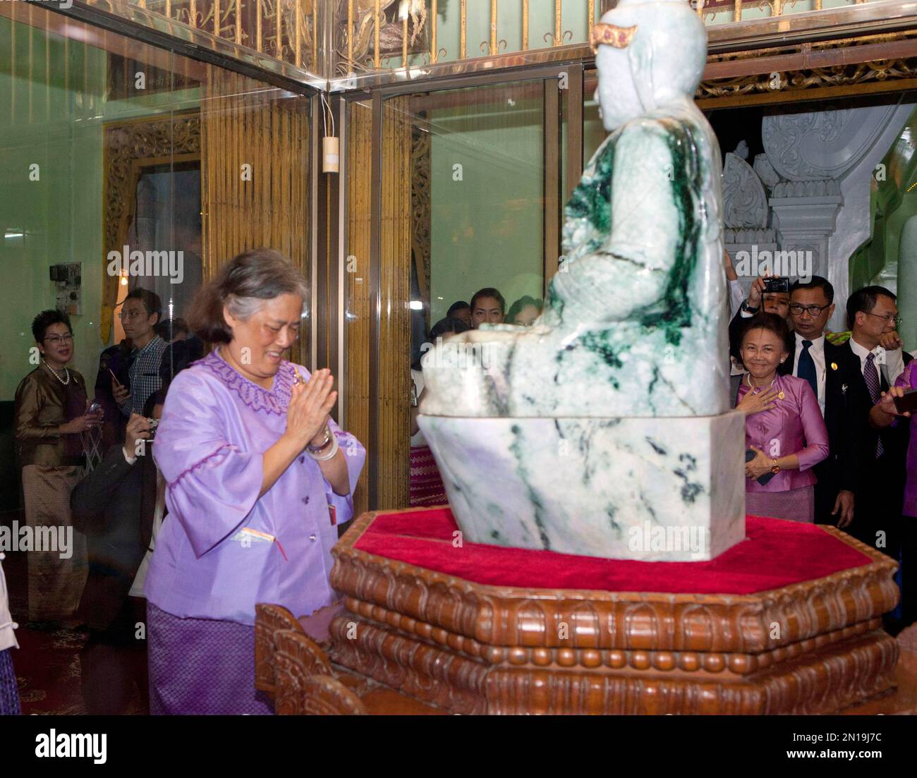Thai Princess Maha Chakri Sirindhorn prays in front of a jade Buddha statue as she visits