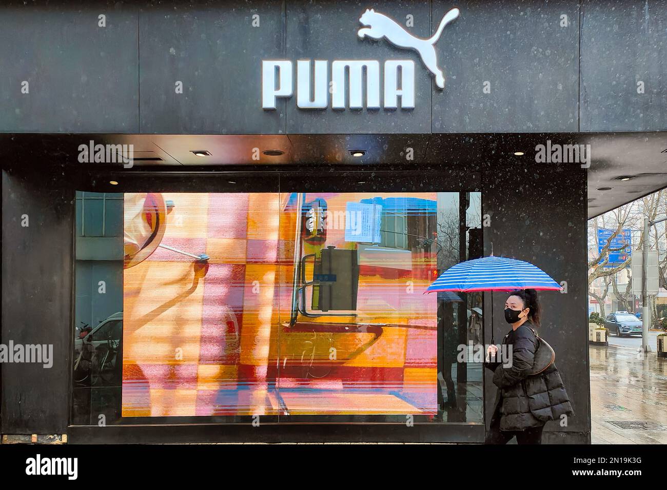 SHANGHAI, CHINA - FEBRUARY 6, 2023 - Citizens walk past PUMA clothing store  in Shanghai, China, February 6, 2023 Stock Photo - Alamy