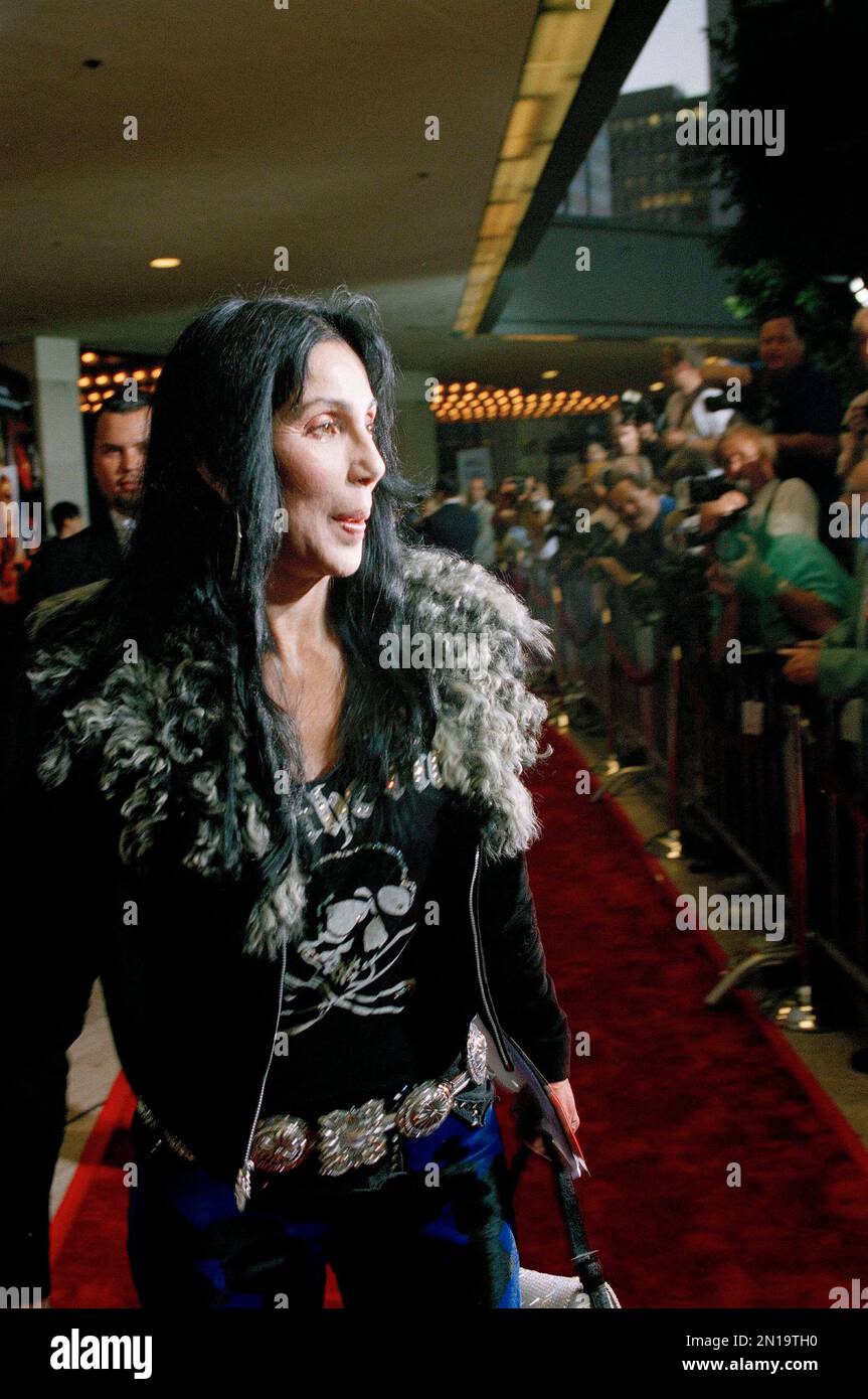 Singer and fashion icon Cher walks past a line of photographers on her ...