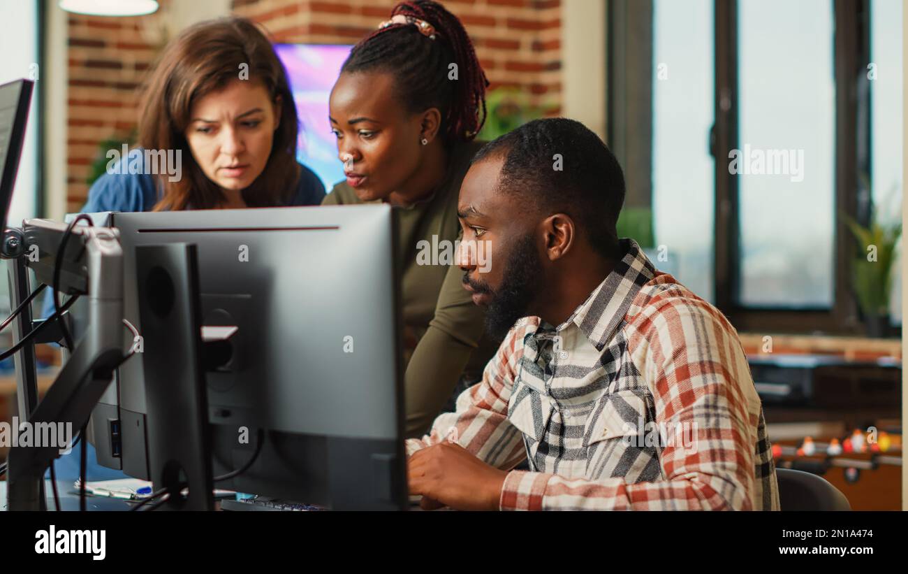 Group of software developers using creative skills to plan new advanced interface, working on engineering development. Colleagues creating industry production component in office. Stock Photo