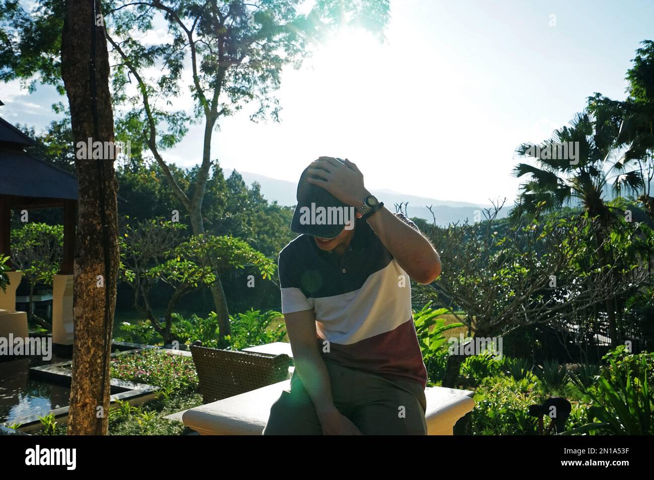 A man with Exterior design of natural hotel and luxury resort villas and pavilions acquainted with Thai culture on terraced rice field, Thailand Stock Photo