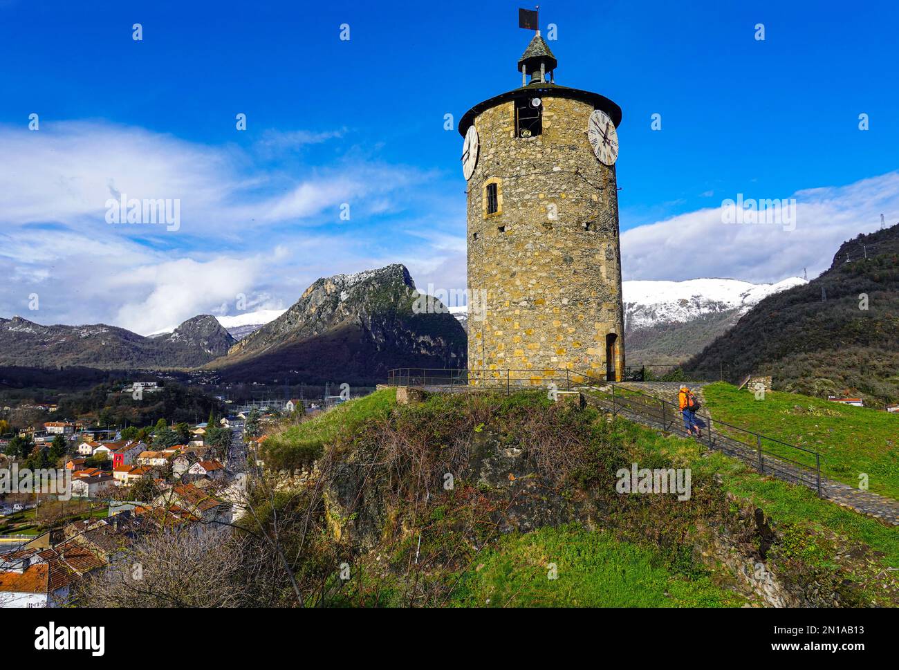 Clocktower above in Tarascon sur Ariege, French Pyrenees, The Ariege, France with snowy mountains Stock Photo