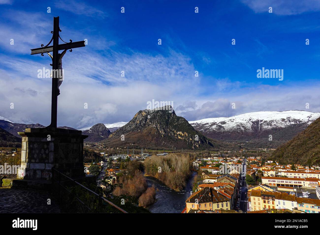 Crucifix and Winter in Tarascon sur Ariege, French Pyrenees, The Ariege, France with snowy mountains Stock Photo