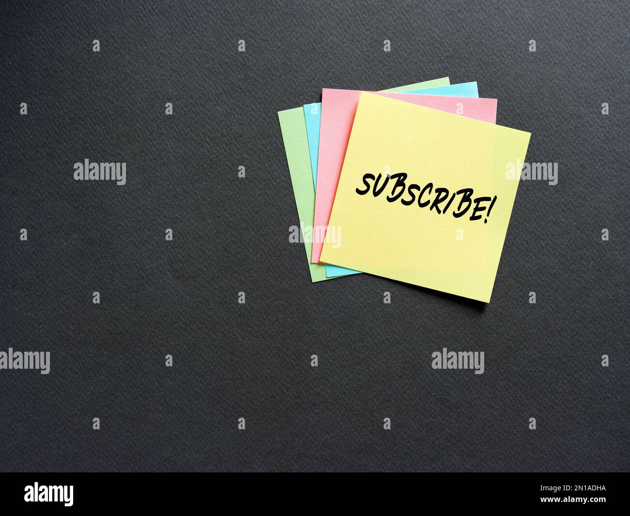 The word subscribe on note paper. Subscription, registration and membership concept. Stock Photo