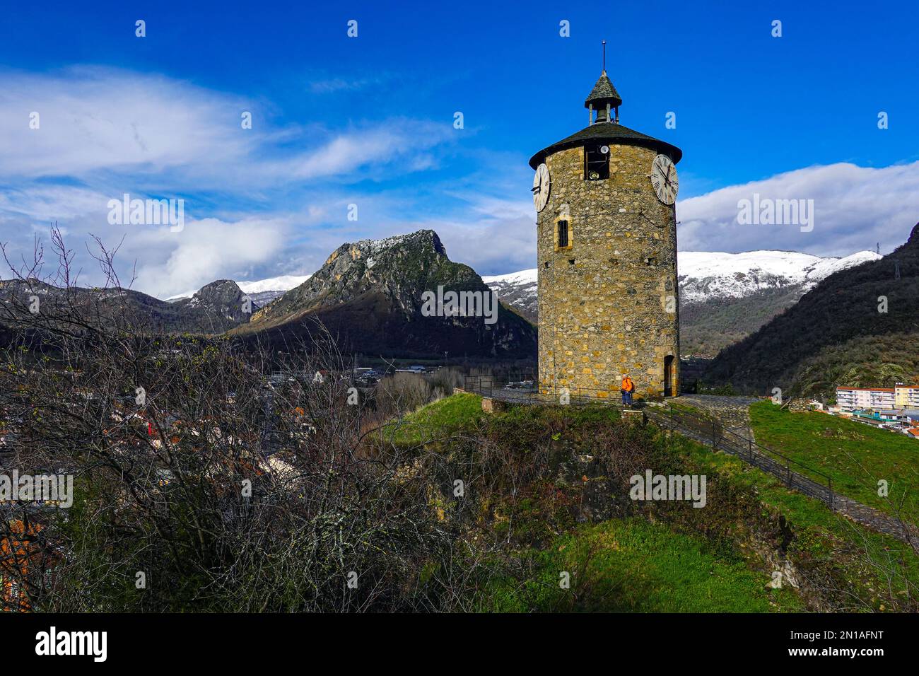 Clocktower above in Tarascon sur Ariege, French Pyrenees, The Ariege, France with snowy mountains Stock Photo