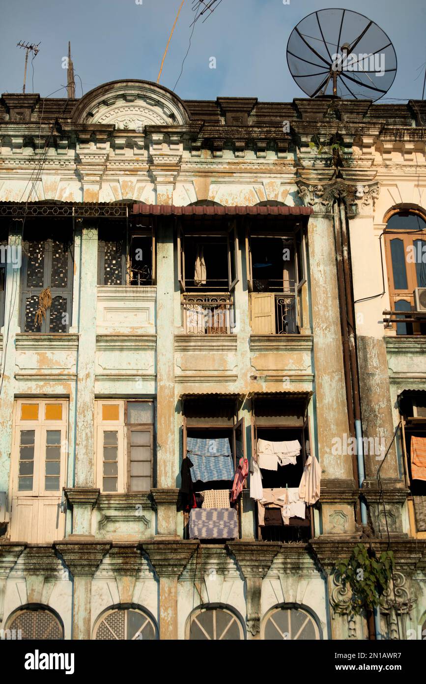 Old building facade with satellite dishes on roof, Yangon, Myanmar ...