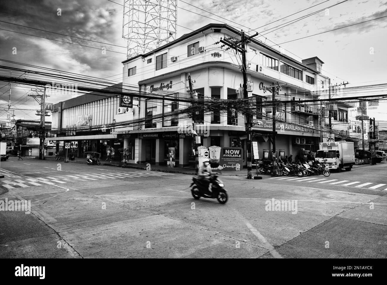 A street surrounded by buildings in Dumaguete Stock Photo Alamy