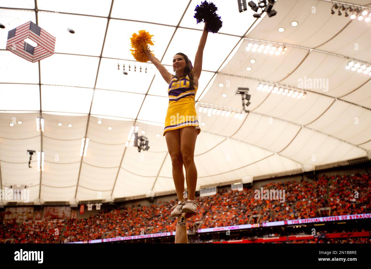 An LSU cheerleader performs during the first half of an NCAA college