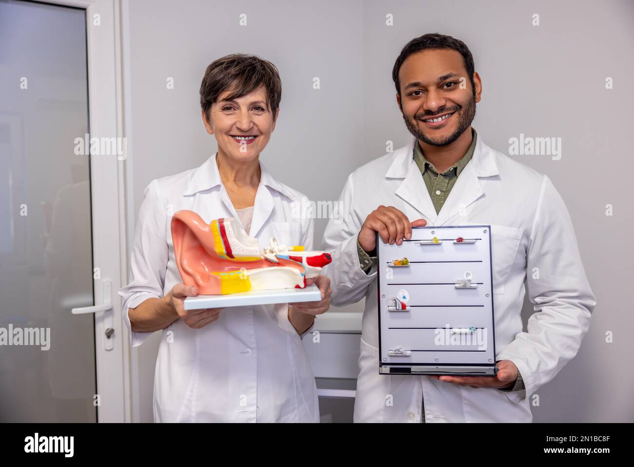 Two ent doctors demonstrating innovative hearing aids Stock Photo Alamy