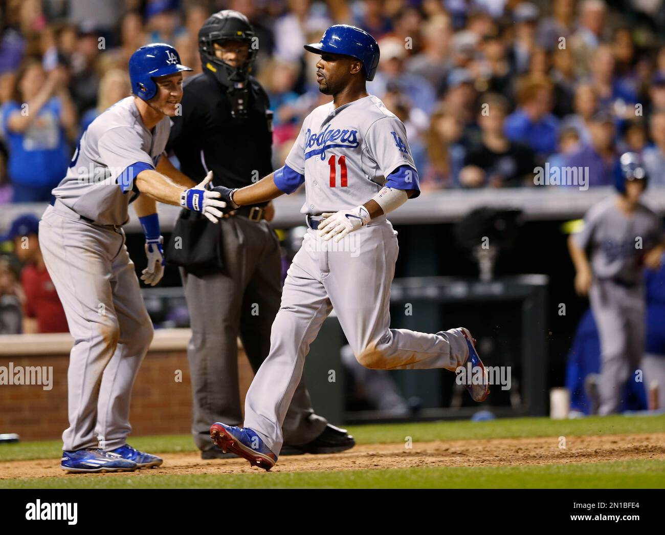 Los Angeles Dodgers' Chase Utley, left, congratulates Jimmy Rollins as they  score on a single by Howie Kendrick off Colorado Rockies relief pitcher Rex  Brothers during the seventh inning of a baseball