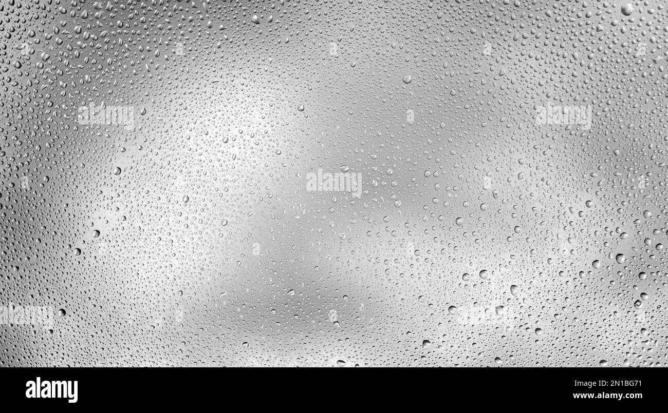 Glowing gray background with contrasting water drops. Stock Photo