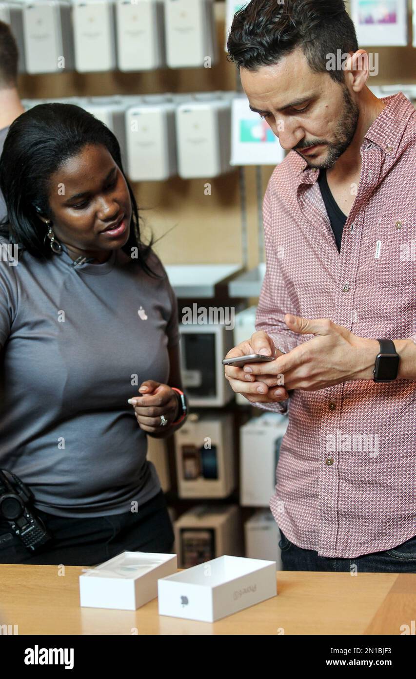 A customer tries out his Apple iPhone 6s smartphone Friday, Sept. 25 ...