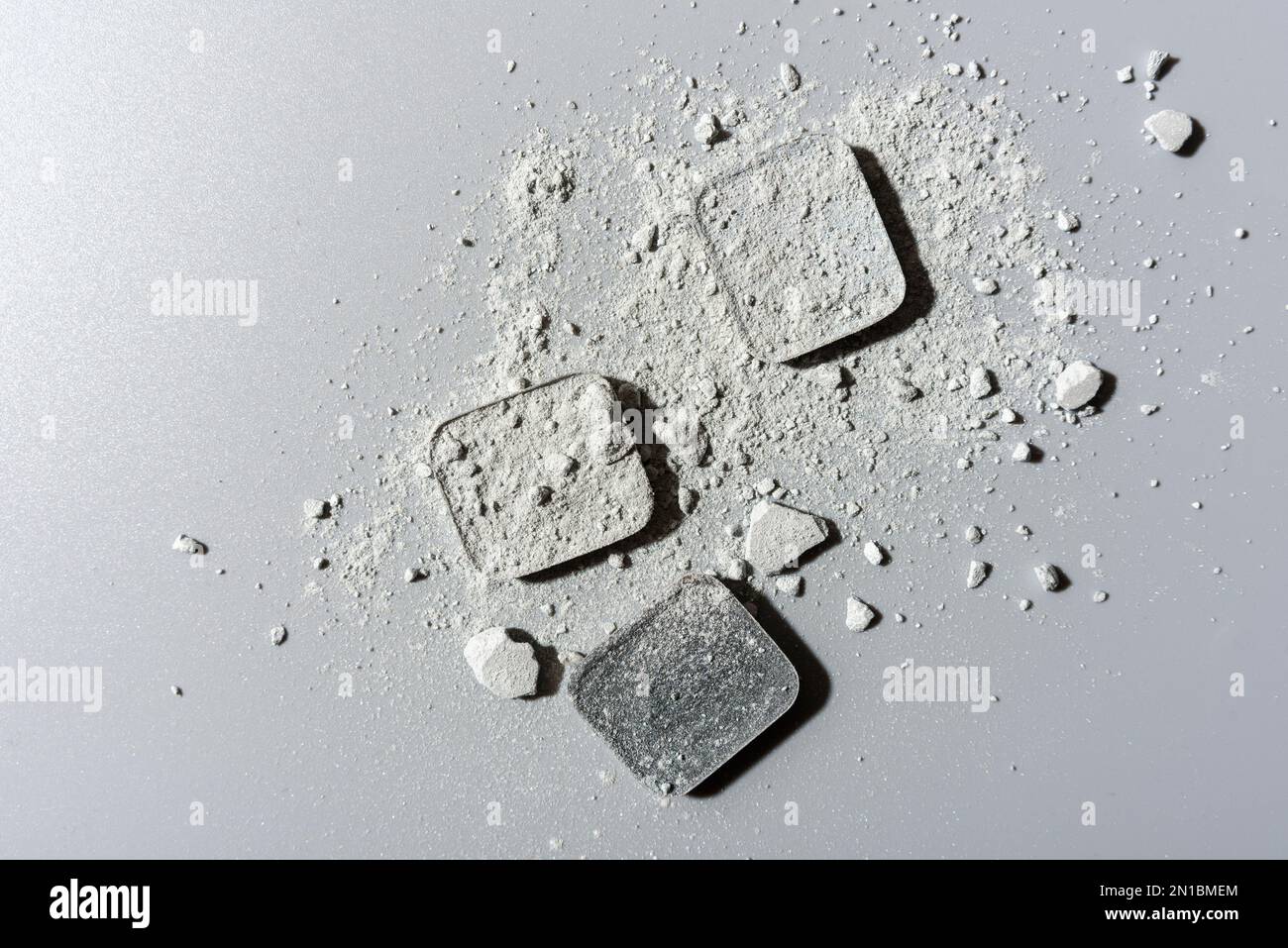 Abstract composition made from crushed grey eye shadows with square cases Stock Photo