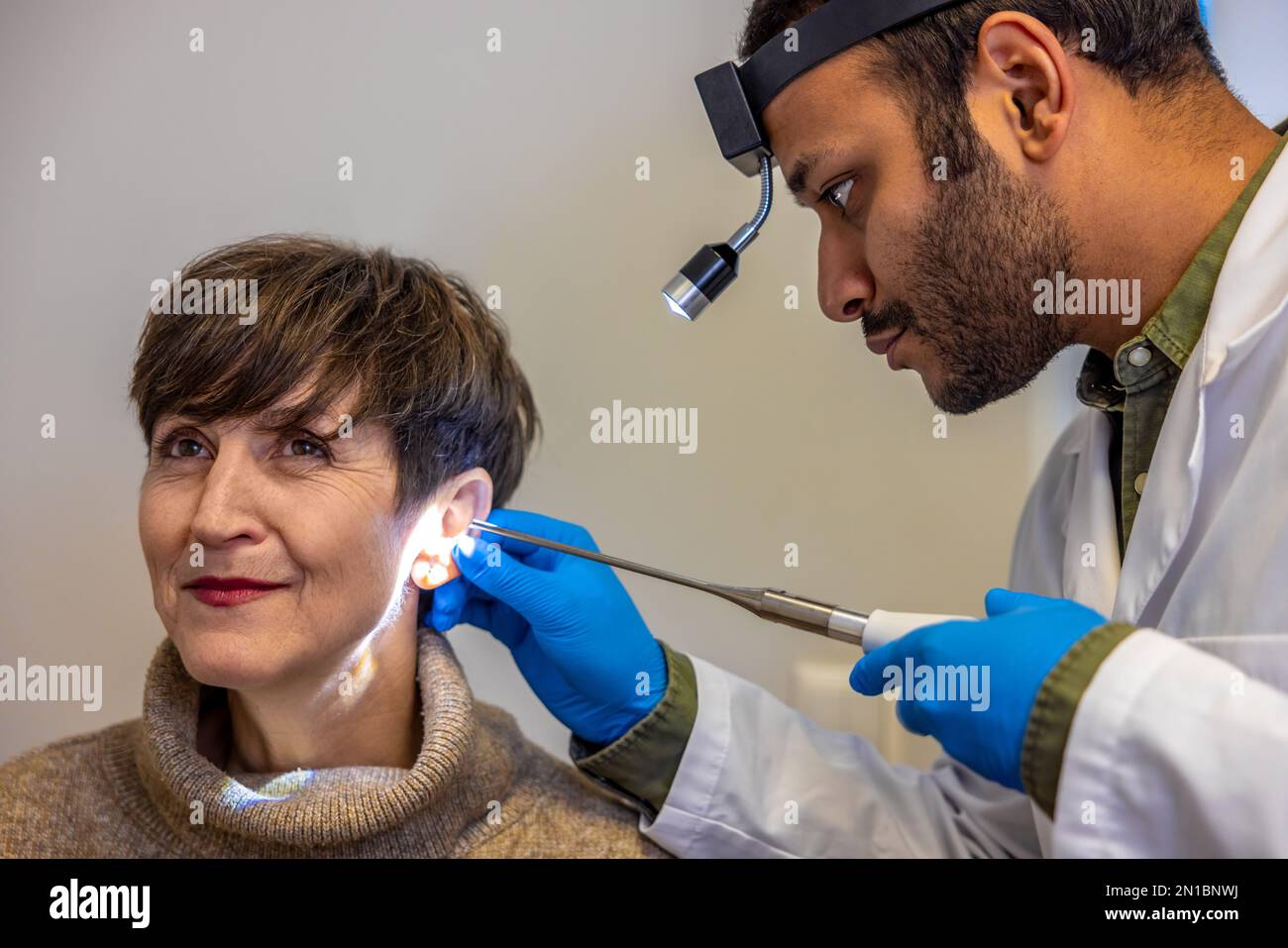 ENT doctor examinine patients ear with endoscope Stock Photo Alamy