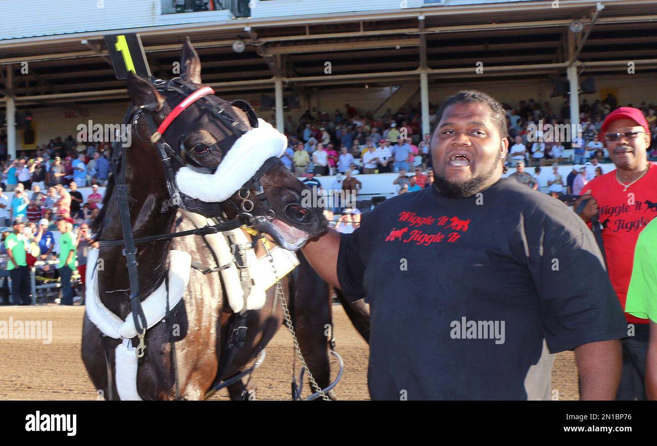 Caretaker “Big” Mike Taylor brings Wiggle It Jiggleit into the winner's  circle after the horse won th Little Brown Jug harness race at the Delaware  County Fairgrounds in Delaware, Ohio, Thursday, Sept.