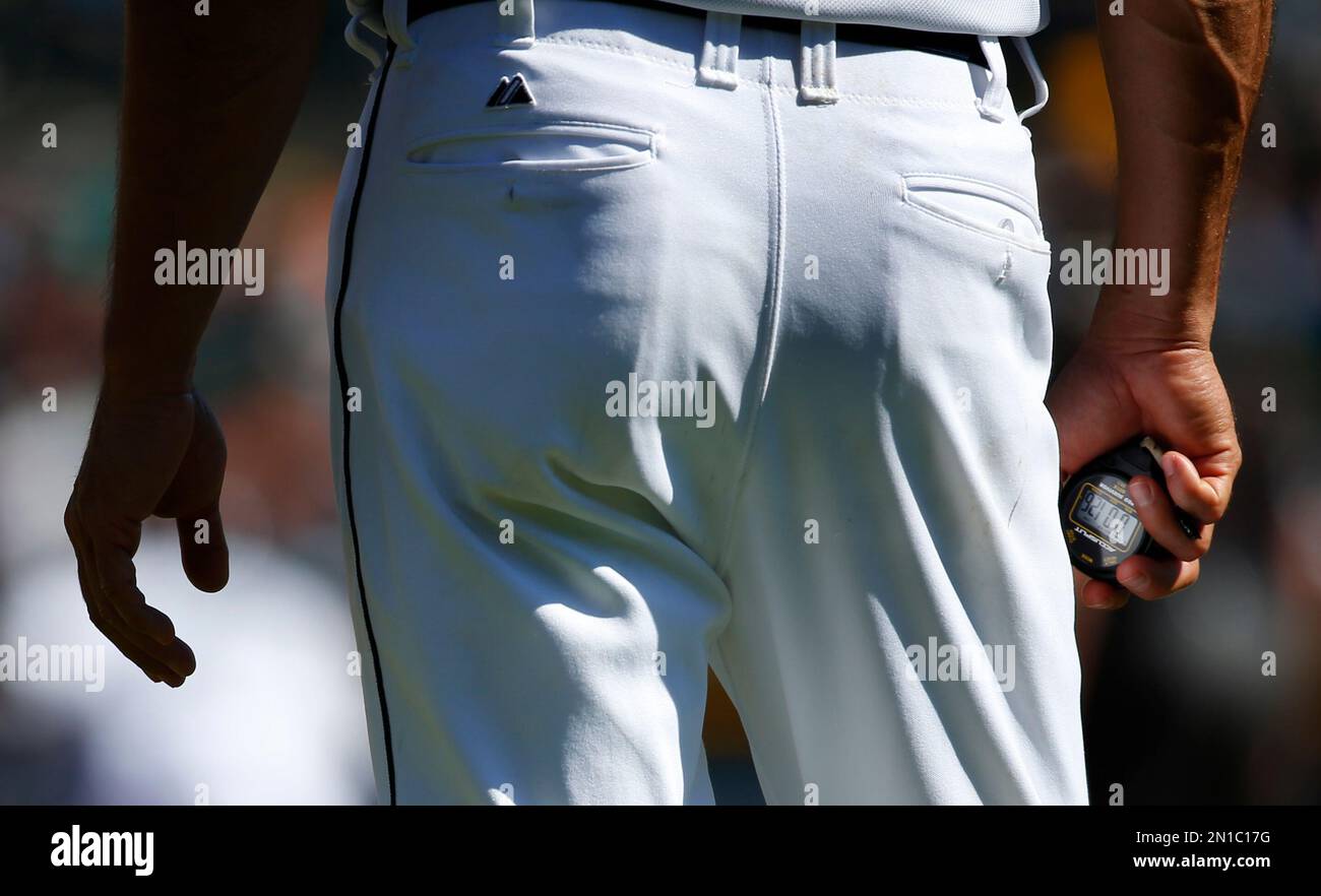Detroit Tigers first base coach Omar Vizquel keeps a stop watch against