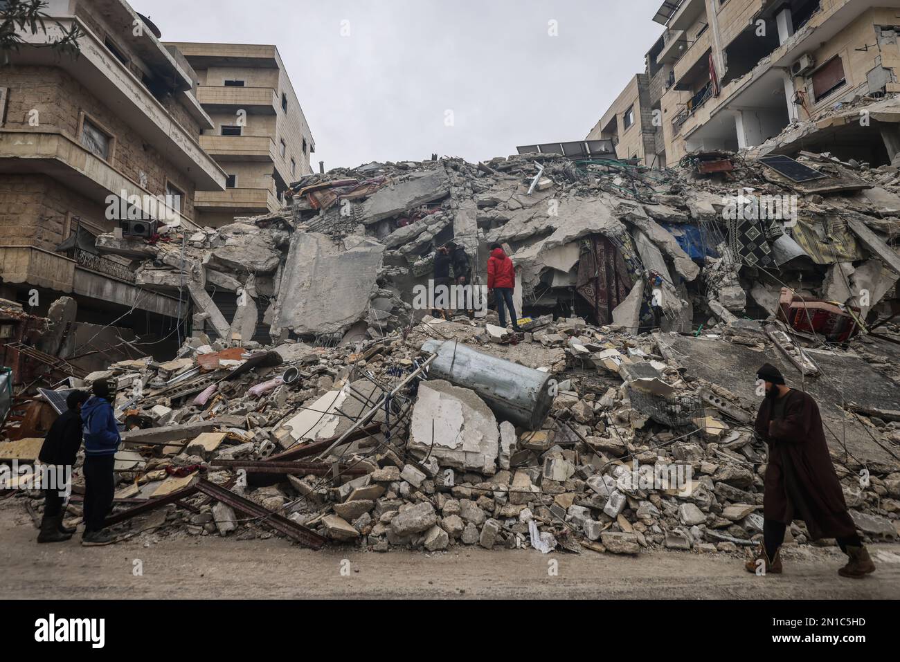 Idlib, Syria. 06th Feb, 2023. Syrian civilians inspect a destroyed residential building after the magnitude 7.8 earthquake that hit northern Syria. Credit: Anas Alkharboutli/dpa/Alamy Live News Stock Photo