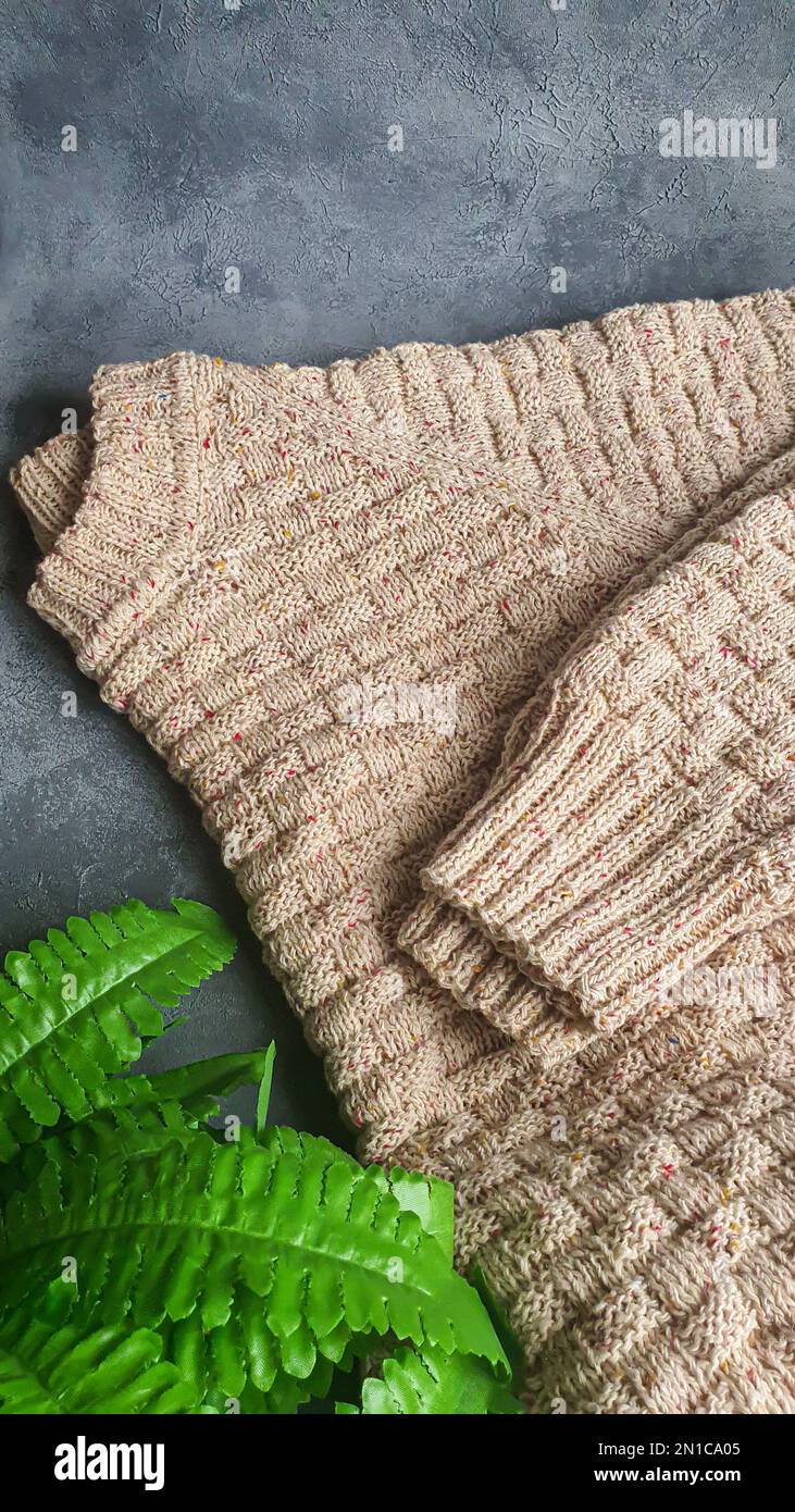 Knitted handmade items. Knitted fabric from colored thread. Bright background. copy space Stock Photo