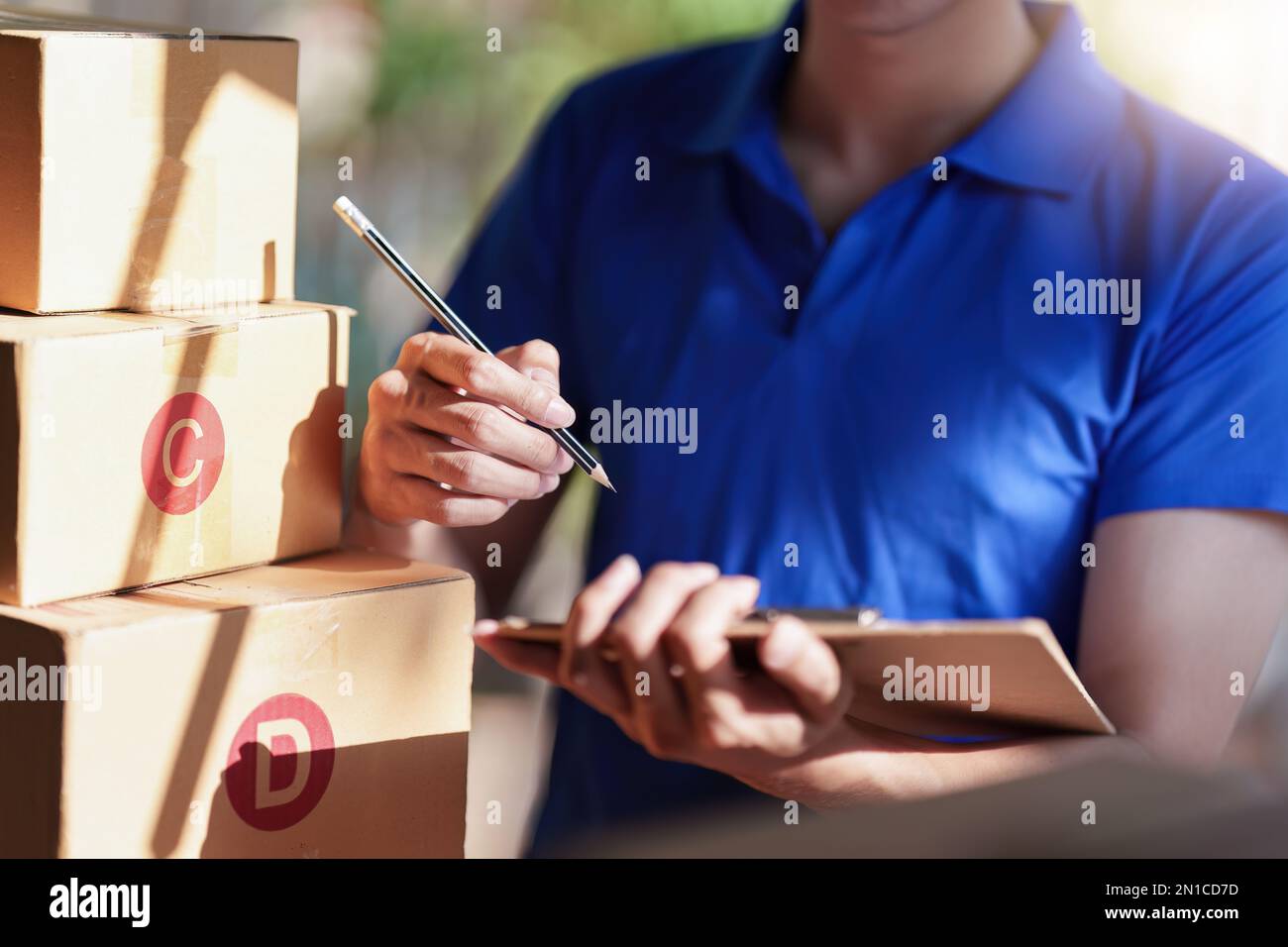 Asian courier with parcel and delivery logistic concept. Delivery man ...