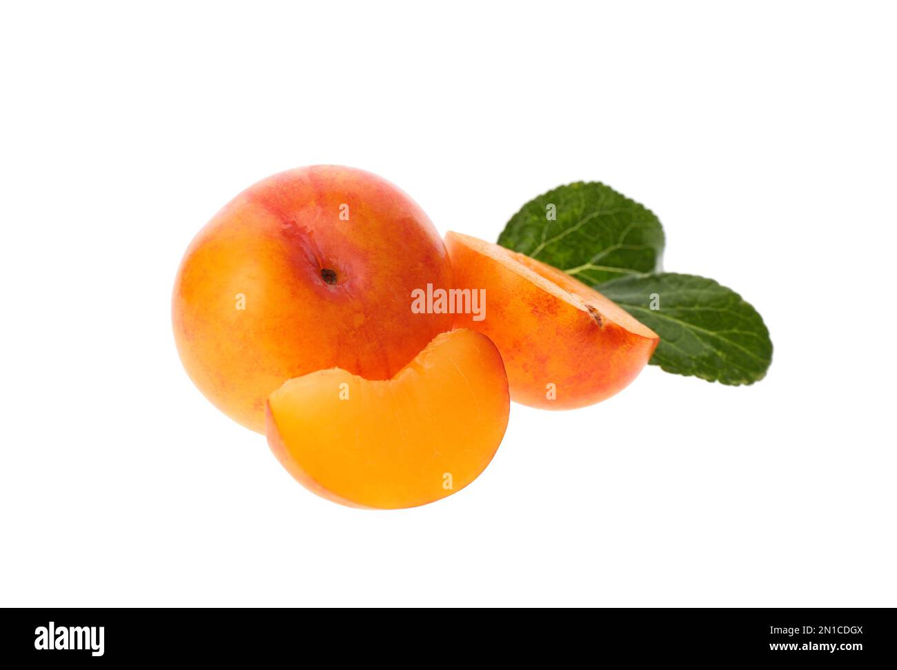 Whole and cut ripe plums with green leaves isolated on white Stock ...