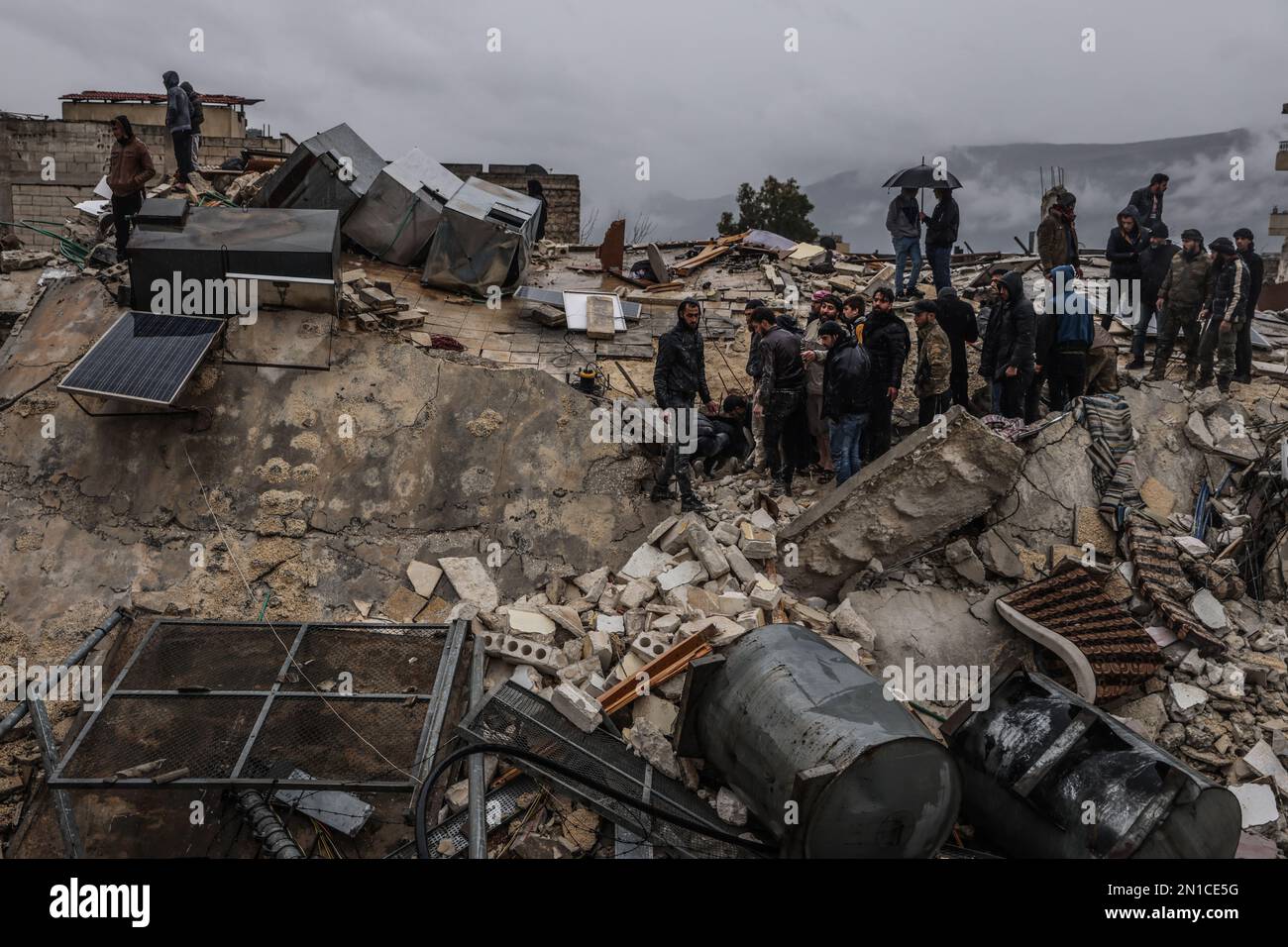 Idlib, Syria. 06th Feb, 2023. Syrian civilians inspect a destroyed residential building following a magnitude 7.8 earthquake that hit Syria. Credit: Anas Alkharboutli/dpa/Alamy Live News Stock Photo