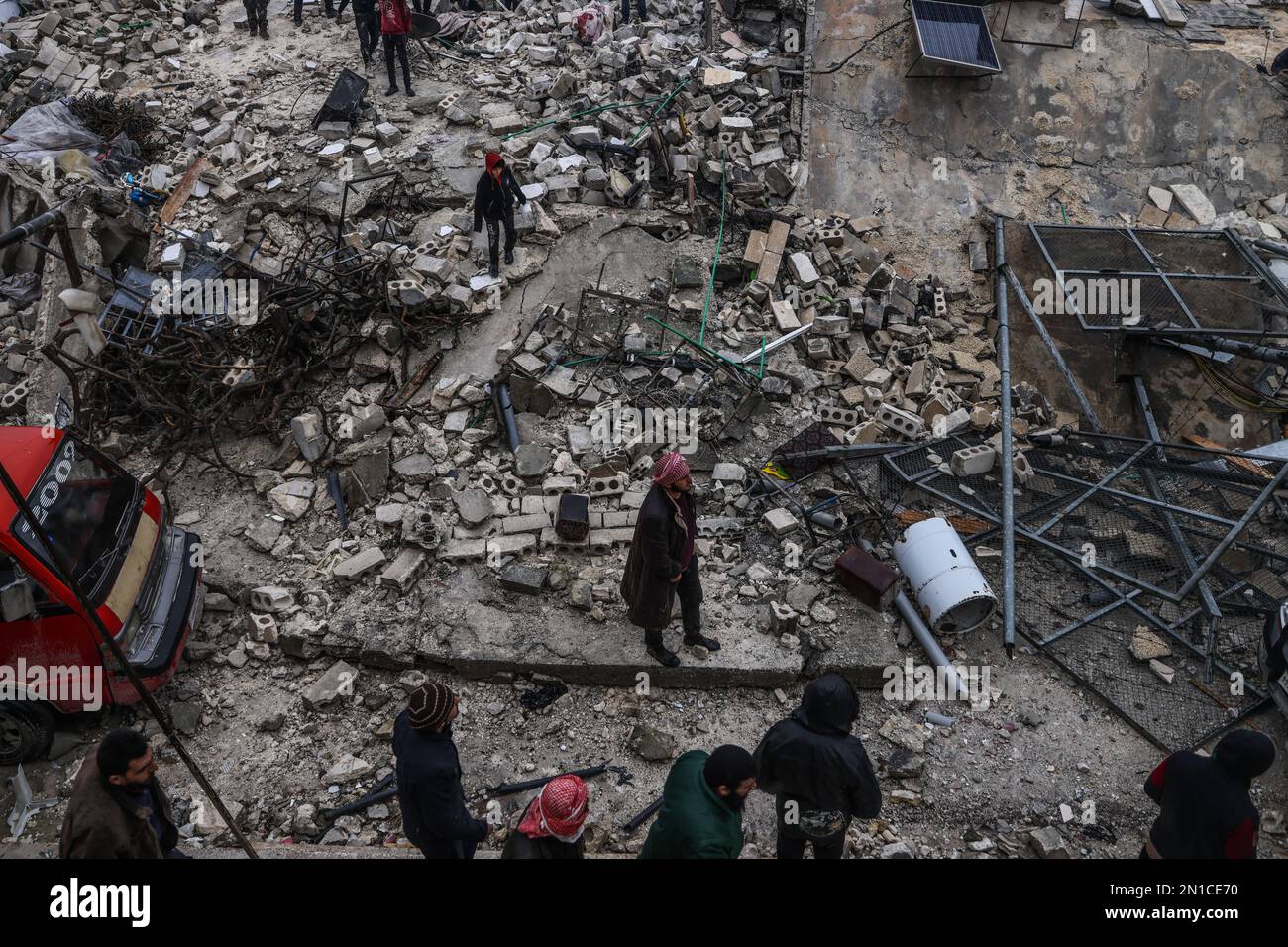 Idlib, Syria. 06th Feb, 2023. Syrian civilians inspect a destroyed residential building following a magnitude 7.8 earthquake that hit Syria. Credit: Anas Alkharboutli/dpa/Alamy Live News Stock Photo