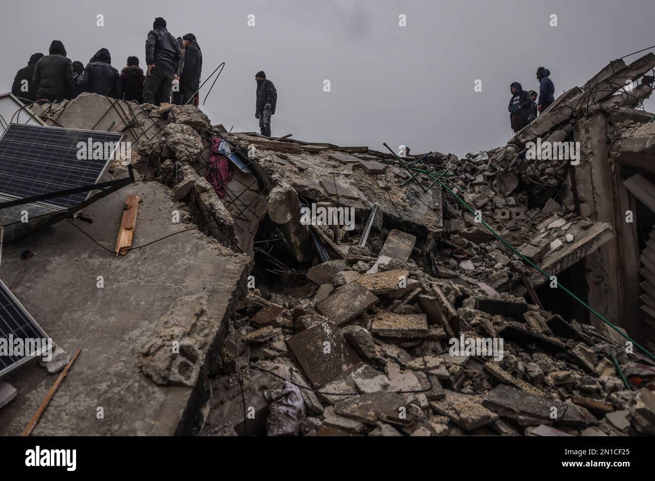 Idlib, Syria. 06th Feb, 2023. Syrian civilians inspect a destroyed residential building following a magnitude 7.8 earthquake that hit Syria. Credit: Anas Alkharboutli/dpa/Alamy Live News Stock Photo