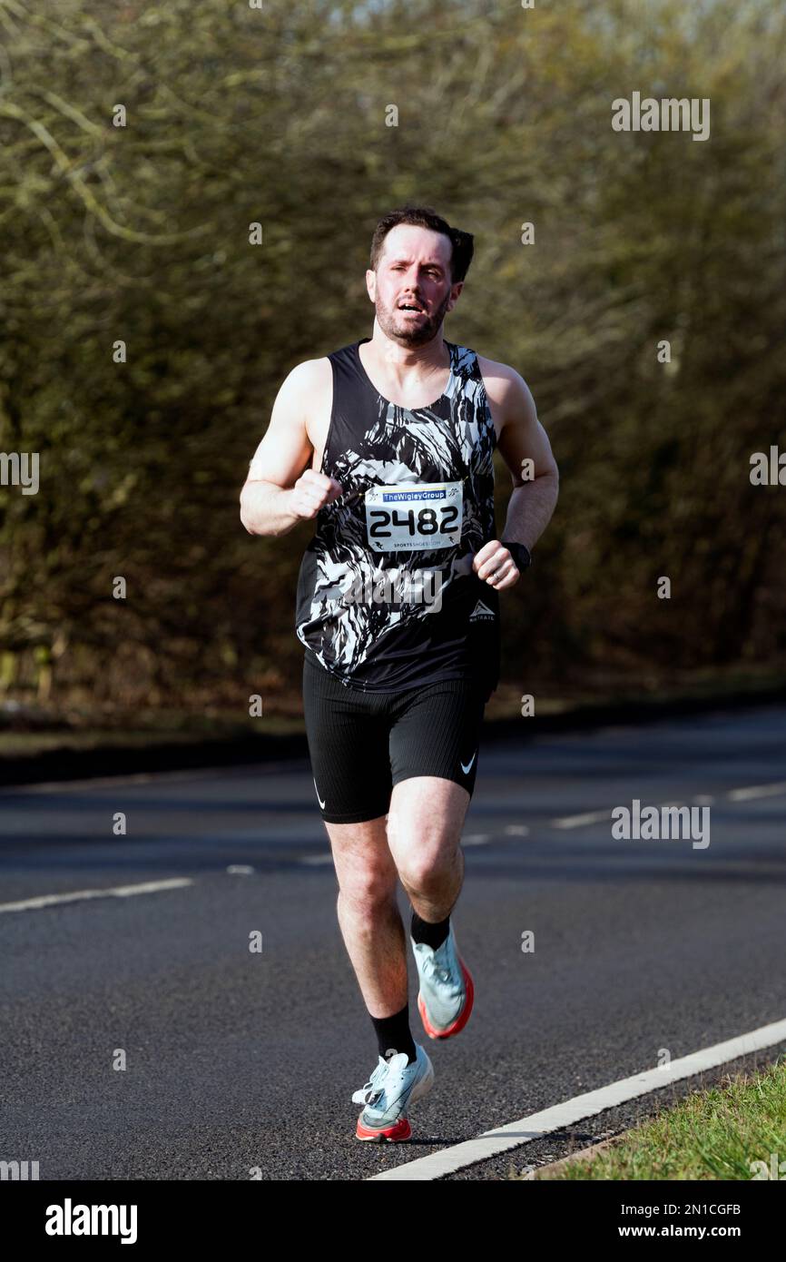 A runner in the Warwick Half Marathon, Warwick, Warwickshire, UK Stock Photo