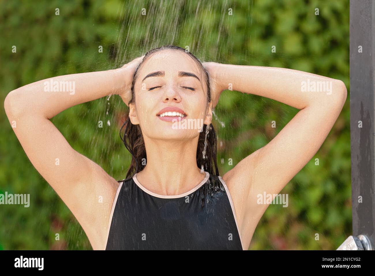 Woman washing hair in outdoor shower on summer day Stock Photo Alamy